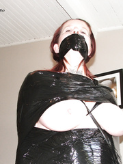 Sandy mummified in black wrapping film