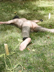 Spread eagle tied outdoors
