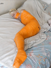Kaylia mummified in orange tape