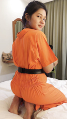 Girl in prison jumpsuit and shackles