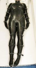 Goth strapped in latex catsuit