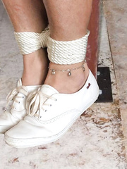 Bound feet wearing leather Keds